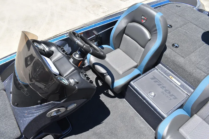 Slide: The Image of 2026 Triton 179 TrX boat interior with steering console and seating. - 20