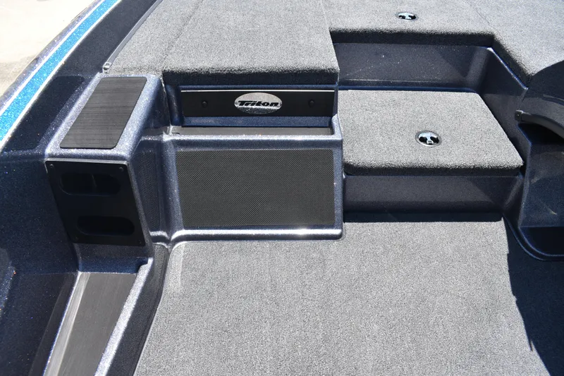 Slide: The Image of 2026 Triton 179 TrX boat interior with carpeted deck and storage compartments. - 23