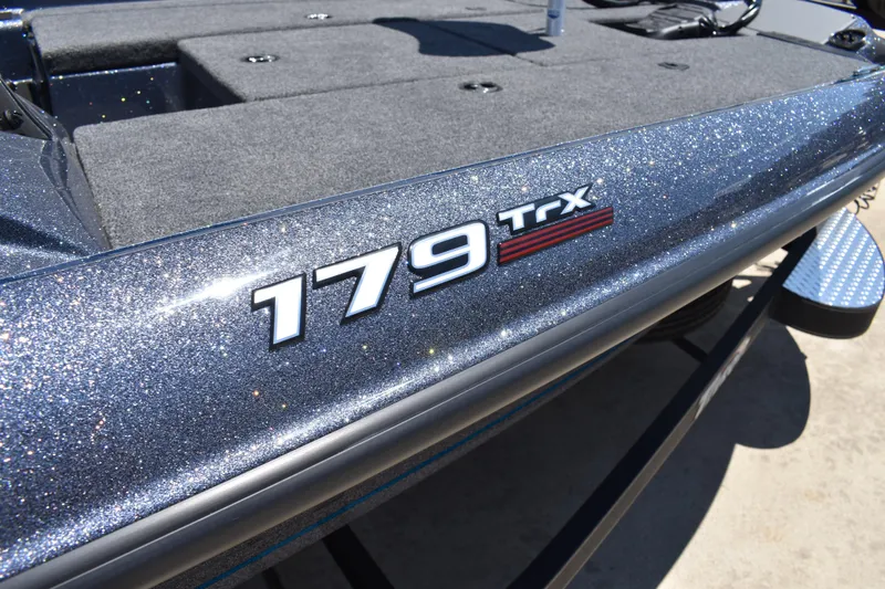 Slide: The Image of 2026 Triton 179 TrX boat with glittery finish and spacious deck. - 3