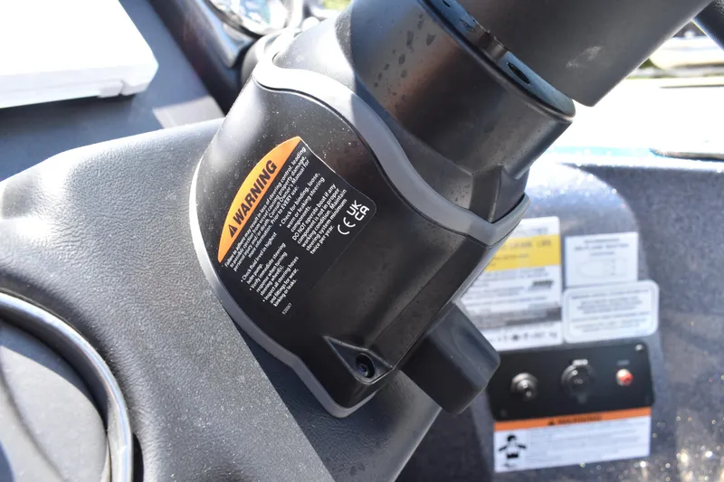 Slide: The Image of Close-up of a 2026 Triton 179 TrX boat dashboard with warning labels. - 31