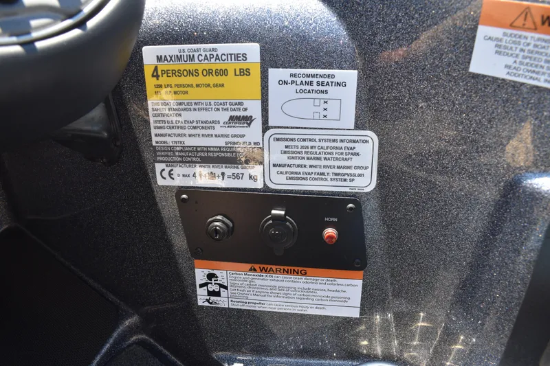 Slide: The Image of Control panel of 2026 Triton 179 TrX boat with capacity and safety labels. - 32