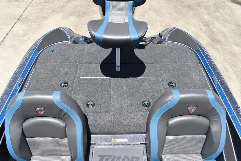 Slide: The Image of 2026 Triton 179 TrX boat interior with blue and gray seating and carpeted deck. - 35