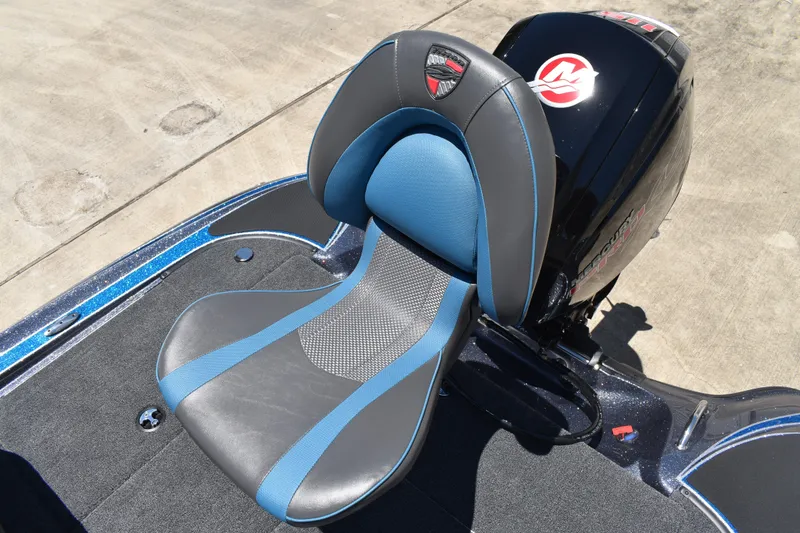 Slide: The Image of 2026 Triton 179 TrX boat seat with blue and gray design, next to a powerful engine. - 36