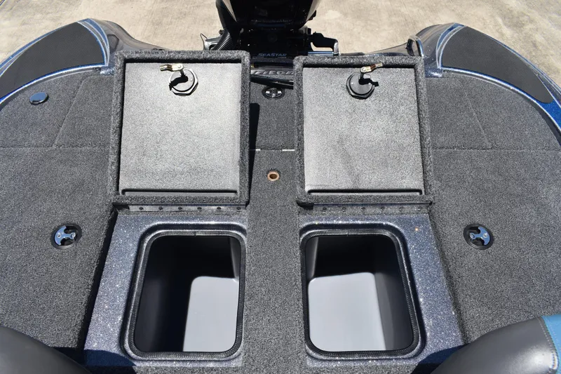 Slide: The Image of 2026 Triton 179 TrX boat deck with storage compartments and carpeted surface. - 38
