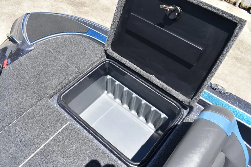 Slide: The Image of Open storage compartment on 2026 Triton 179 TrX boat, featuring carpeted interior. - 39