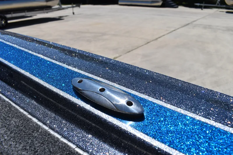 Slide: The Image of 2026 Triton 179 TrX boat with sparkling blue metallic finish detail. - 42