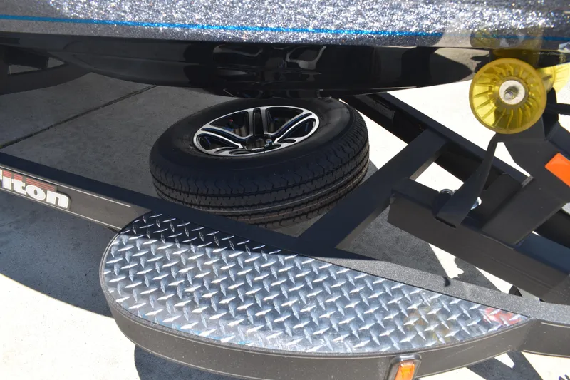 Slide: The Image of 2026 Triton 179 TrX boat trailer with spare tire and diamond plate step. - 48