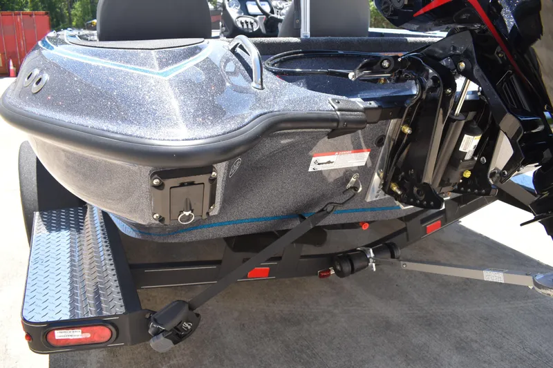 Slide: The Image of 2026 Triton 179 TrX boat rear view, showcasing motor mount and trailer details. - 7