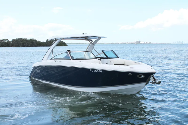 Slide: The Image of 2017 Cobalt R30 boat cruising on open water under a clear sky. - 12
