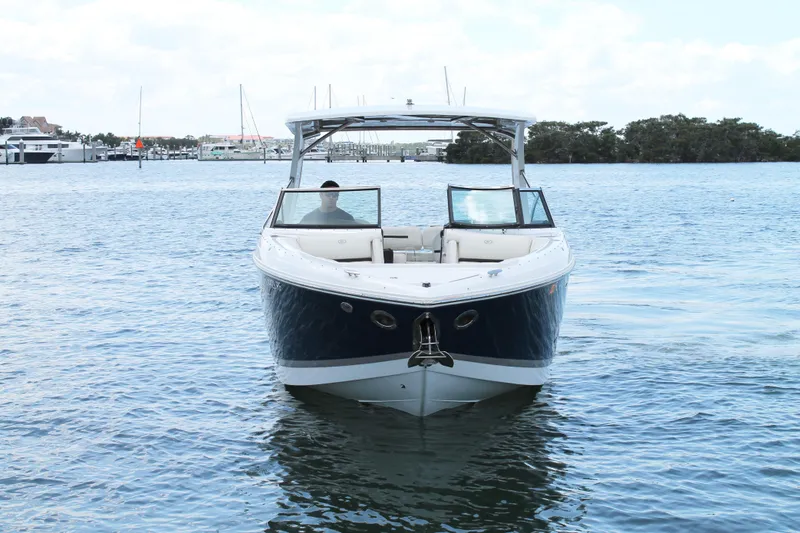 Slide: The Image of 2017 Cobalt R30 boat on calm water, front view with clear sky background. - 13