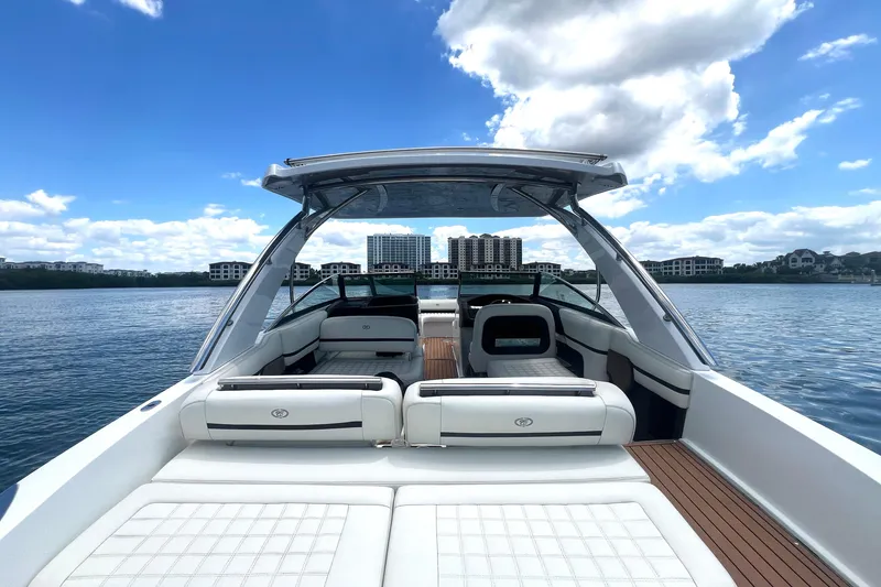 Slide: The Image of 2017 Cobalt R30 boat interior with luxurious seating on a serene lake. - 14