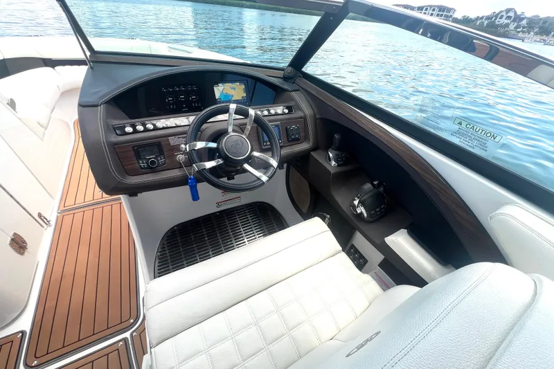 Slide: The Image of Cockpit of 2017 Cobalt R30 boat with steering wheel and navigation display. - 18