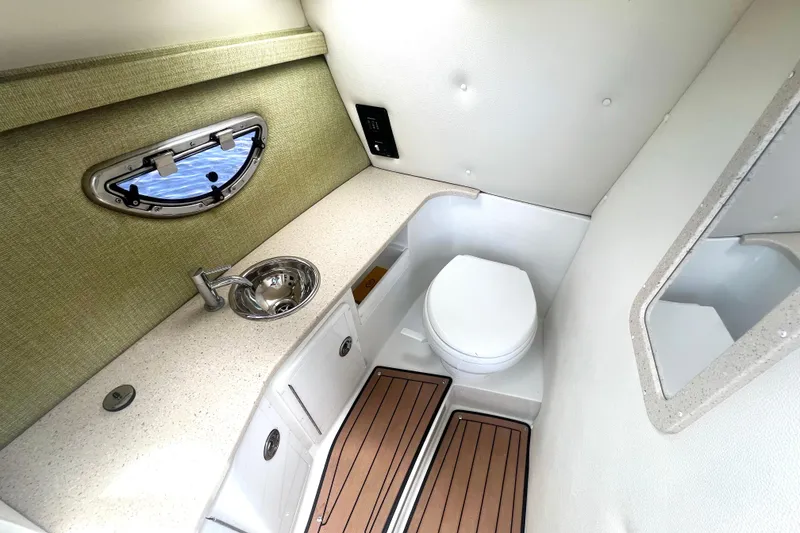 Slide: The Image of 2017 Cobalt R30 boat bathroom with sink, toilet, and window. - 26