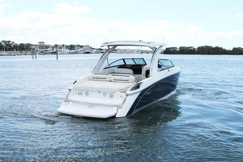 Slide: The Image of 2017 Cobalt R30 boat cruising on a calm lake near a marina. - 8