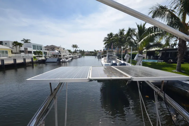Slide: The Image of Solar panels on a 1992 Hinckley Sou'wester 59 yacht docked in a scenic canal. - 10