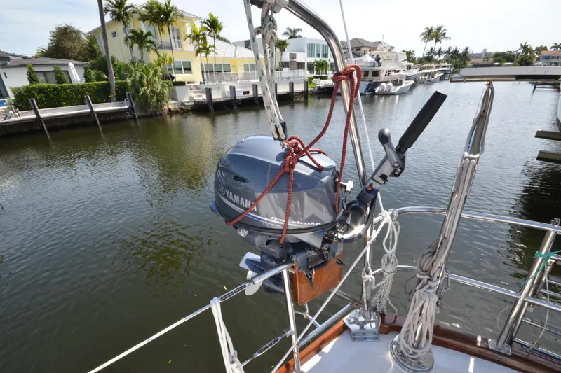 Slide: The Image of Hinckley Sou'wester 59 sailboat with Yamaha outboard motor, docked in a scenic canal. - 11
