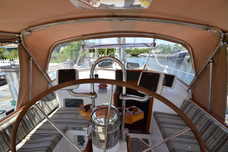 Slide: The Image of Cockpit of 1992 Hinckley Sou'wester 59 sailboat with striped seating and navigation equipment. - 17