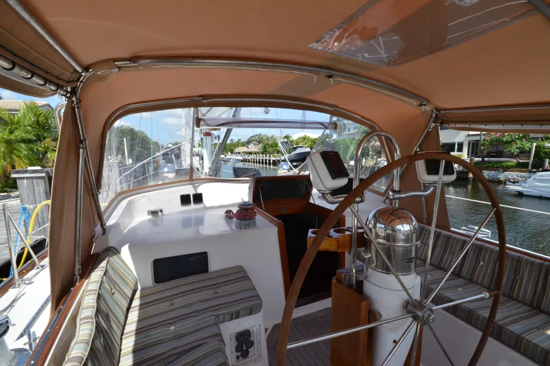 Slide: The Image of Cockpit of 1992 Hinckley Sou'wester 59 sailboat with wooden wheel and striped seating. - 18