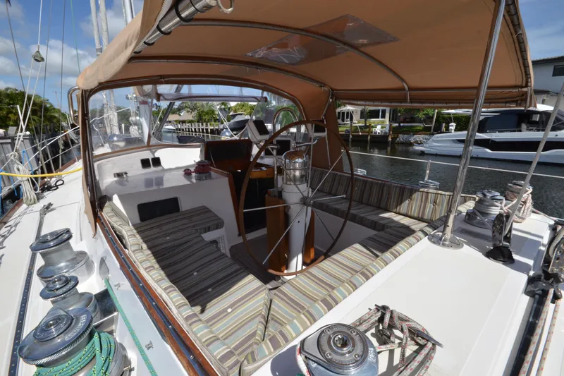 Slide: The Image of Cockpit of 1992 Hinckley Sou'wester 59 sailboat with striped seating and wooden steering wheel. - 19