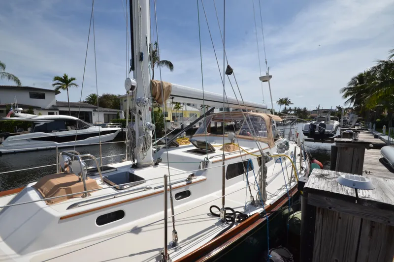 Slide: The Image of Sailboat docked in marina, 1992 Hinckley Sou'wester 59, sunny day, palm trees in background. - 2