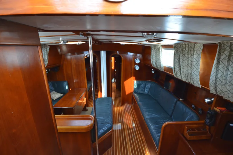 Slide: The Image of Interior of 1992 Hinckley Sou'wester 59 yacht with wooden finish and blue seating. - 20