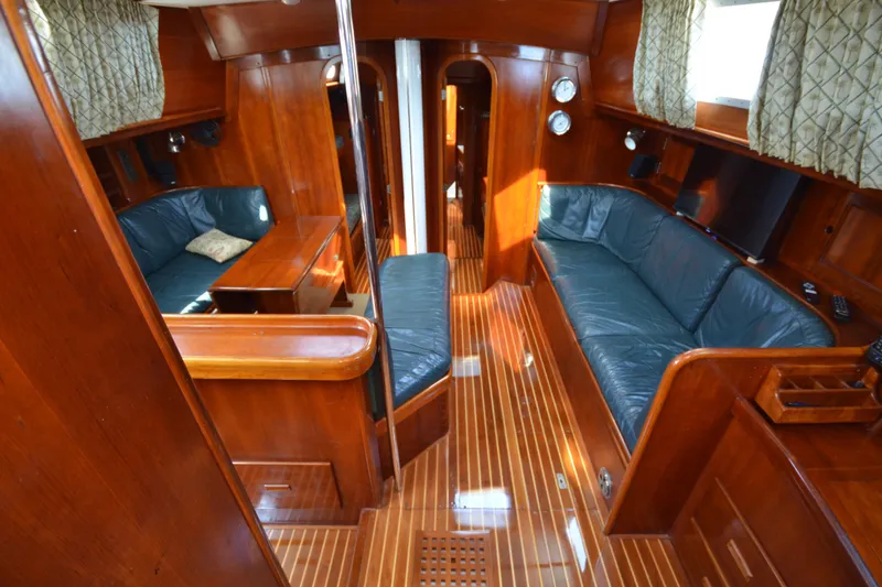 Slide: The Image of Luxurious interior of 1992 Hinckley Sou'wester 59 yacht with polished wood and leather seating. - 22