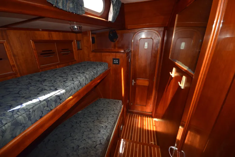 Slide: The Image of Interior of 1992 Hinckley Sou'wester 59 yacht with wooden bunk beds and cabinetry. - 30