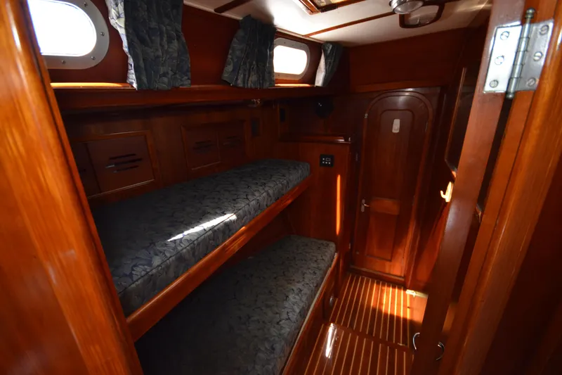 Slide: The Image of Cozy wooden cabin interior of 1992 Hinckley Sou'wester 59 sailboat with bunk beds. - 31