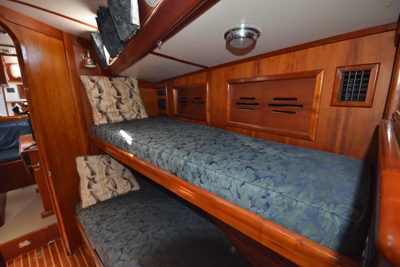 Slide: The Image of Interior of 1992 Hinckley Sou'wester 59 yacht with wooden bunk beds and floral cushions. - 32