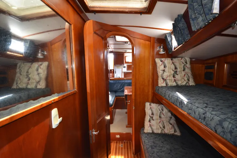 Slide: The Image of Interior of 1992 Hinckley Sou'wester 59 yacht with wooden bunk beds and nautical decor. - 33