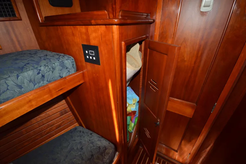 Slide: The Image of Interior of 1992 Hinckley Sou'wester 59 yacht with wooden bunk beds and storage. - 35
