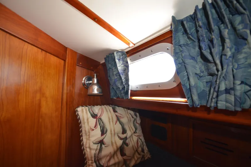 Slide: The Image of Cozy cabin interior of 1992 Hinckley Sou'wester 59 with wood paneling and nautical decor. - 36