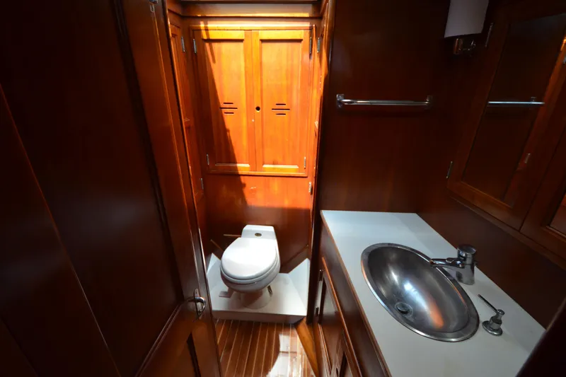Slide: The Image of Luxurious wooden bathroom interior of 1992 Hinckley Sou'wester 59 yacht with sink and toilet. - 39