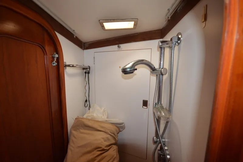 Slide: The Image of Shower area inside 1992 Hinckley Sou'wester 59 yacht with wooden accents. - 40