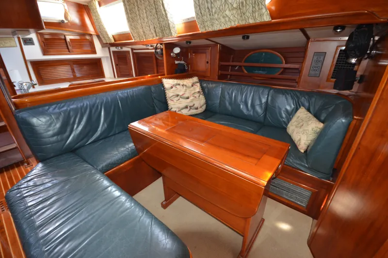 Slide: The Image of Luxurious interior of 1992 Hinckley Sou'wester 59 yacht with leather seating and wooden table. - 46