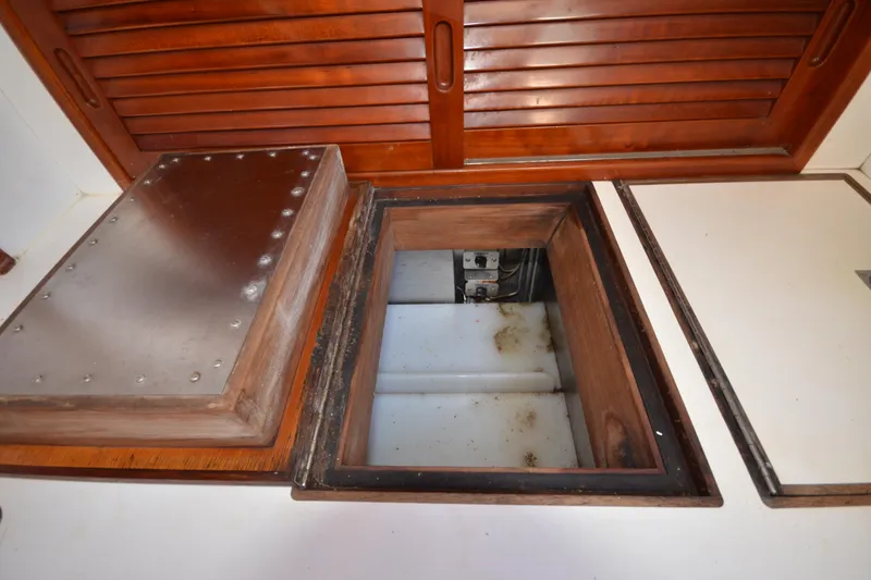 Slide: The Image of Open hatch on 1992 Hinckley Sou'wester 59 yacht, revealing storage compartment. - 50