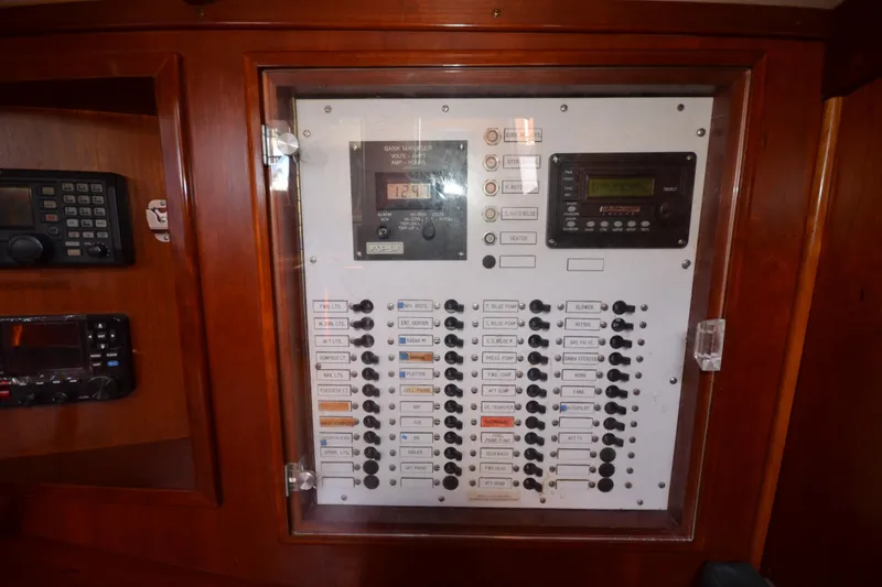 Slide: The Image of Electrical control panel on 1992 Hinckley Sou'wester 59 yacht, featuring switches and displays. - 52