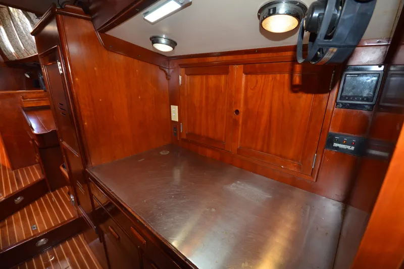 Slide: The Image of Interior of 1992 Hinckley Sou'wester 59 yacht with wooden cabinetry and stainless steel countertop. - 54