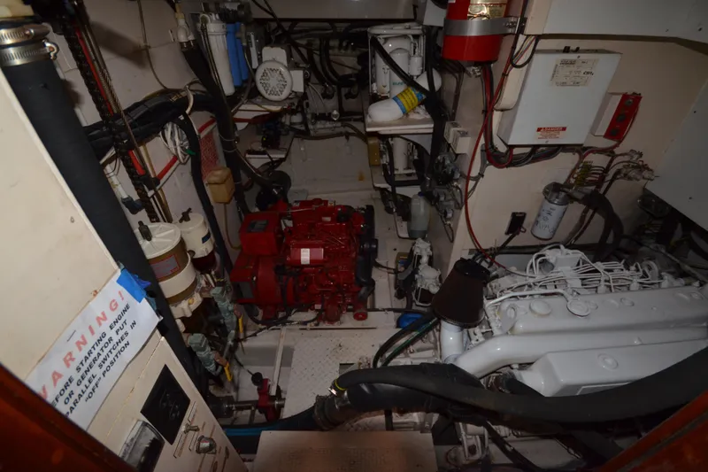 Slide: The Image of Engine room of a 1992 Hinckley Sou'wester 59 yacht, showcasing machinery and wiring. - 56