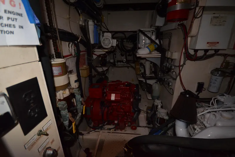 Slide: The Image of Engine room of a 1992 Hinckley Sou'wester 59 yacht, featuring mechanical components and wiring. - 57