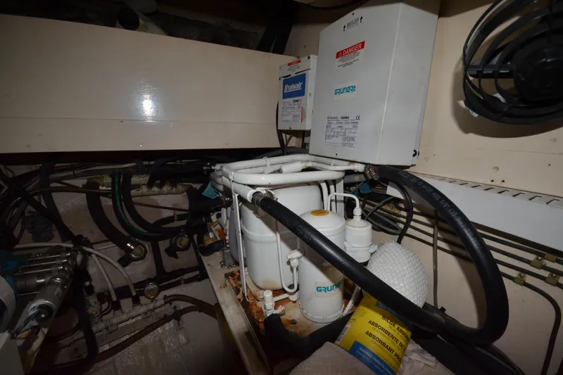 Slide: The Image of Engine room of 1992 Hinckley Sou'wester 59 yacht, featuring mechanical components and wiring. - 60