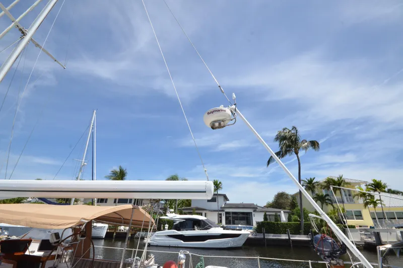 Slide: The Image of Hinckley Sou'wester 59 sailboat docked, featuring mast and radar, under clear blue sky. - 67