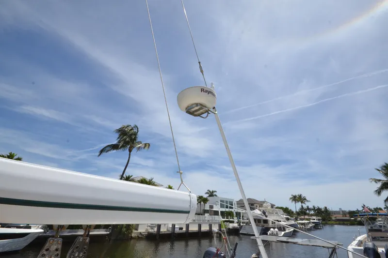 Slide: The Image of Sailboat mast and radar on 1992 Hinckley Sou'wester 59, docked near palm trees. - 68