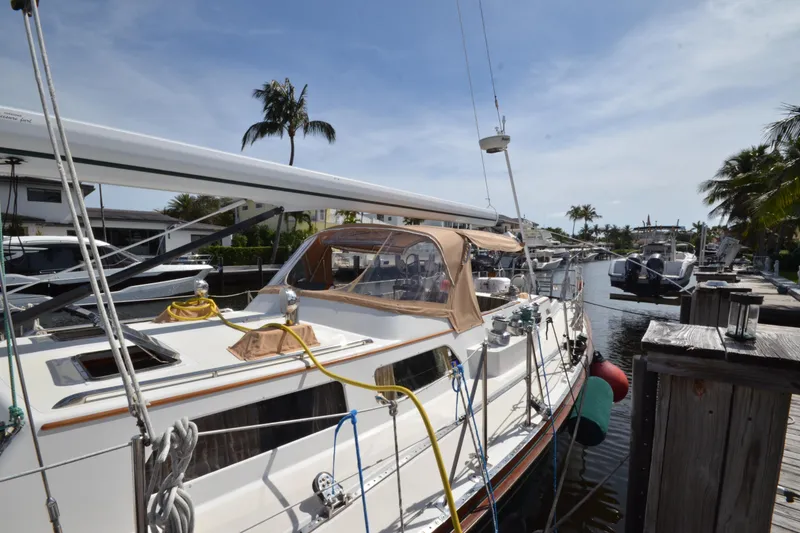 Slide: The Image of Hinckley Sou'wester 59 yacht docked at marina, 1992 model, with palm trees in background. - 7