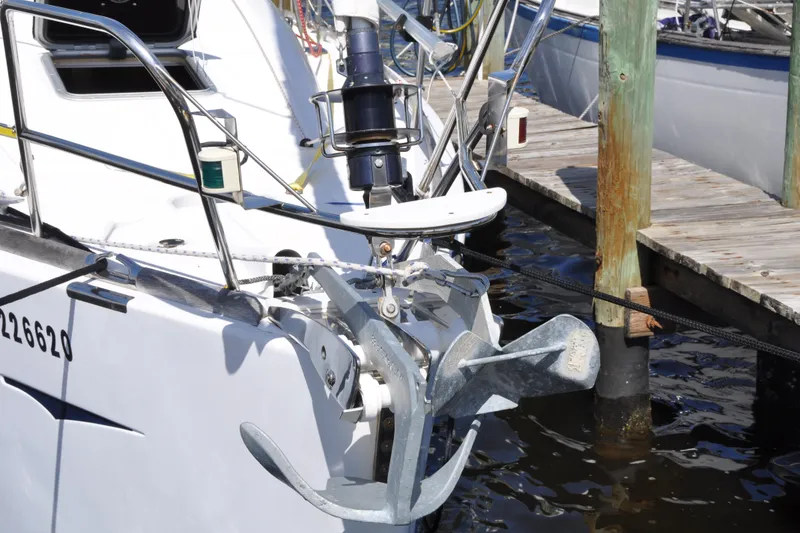 Slide: The Image of Jeanneau Sun Odyssey 36i sailboat anchored at dock, showcasing anchor and bow details. - 1