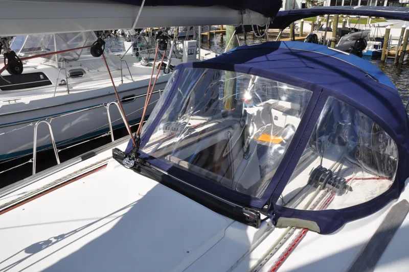 Slide: The Image of Jeanneau Sun Odyssey 36i sailboat, 2010 model, featuring a blue cockpit cover and marina setting. - 11