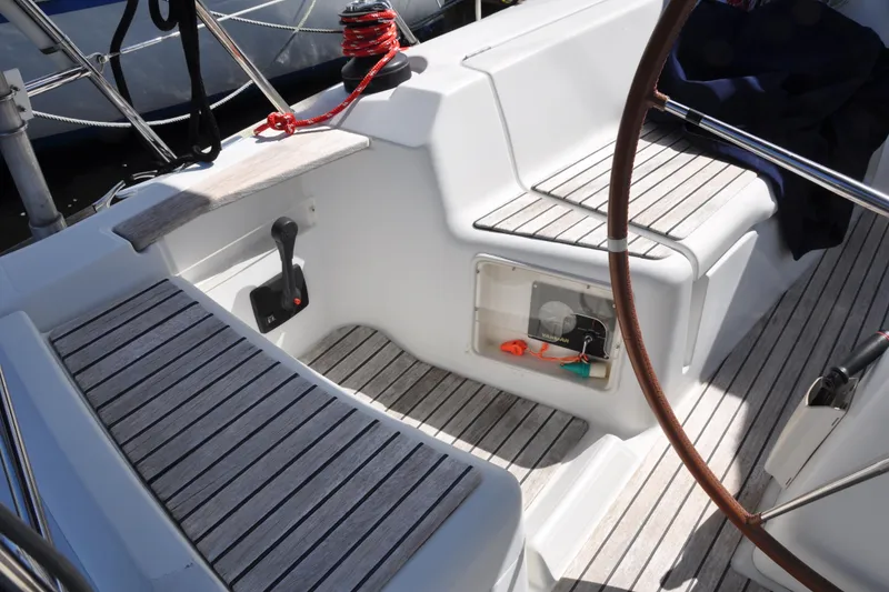 Slide: The Image of Cockpit of 2010 Jeanneau Sun Odyssey 36i sailboat with wooden seating and steering wheel. - 19