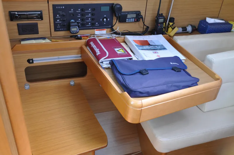 Slide: The Image of Navigation station on 2010 Jeanneau Sun Odyssey 36i yacht with charts and equipment. - 26