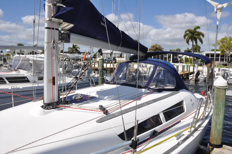 Slide: The Image of 2010 Jeanneau Sun Odyssey 36i sailboat docked at marina under blue sky. - 3