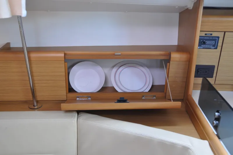 Slide: The Image of Interior of 2010 Jeanneau Sun Odyssey 36i yacht with wooden cabinetry and stored plates. - 30